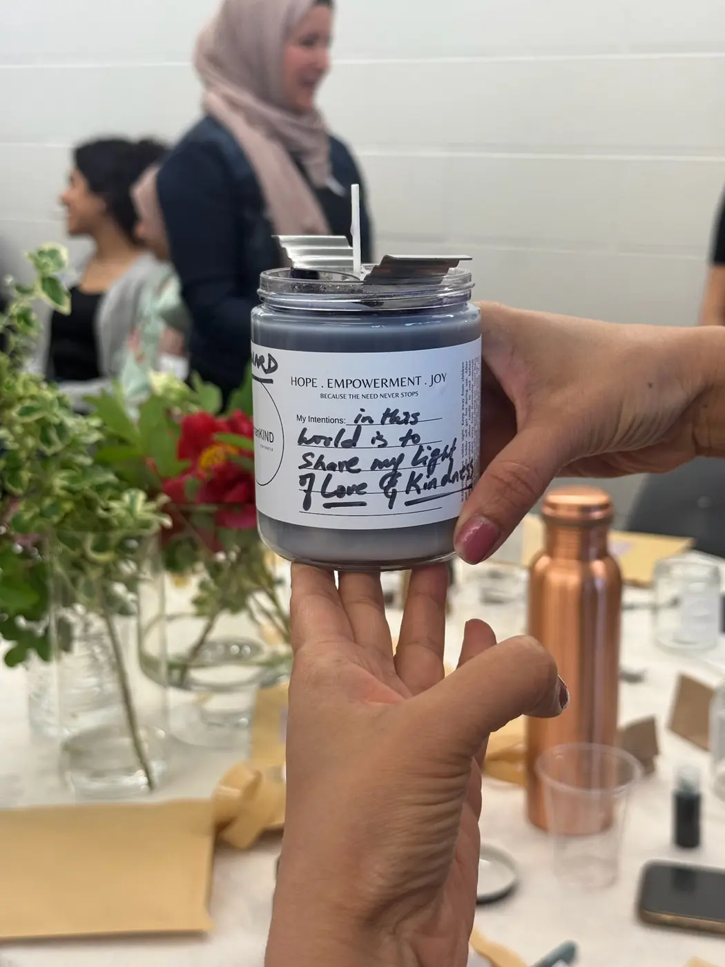 A finished hand-poured candle with a handwritten label