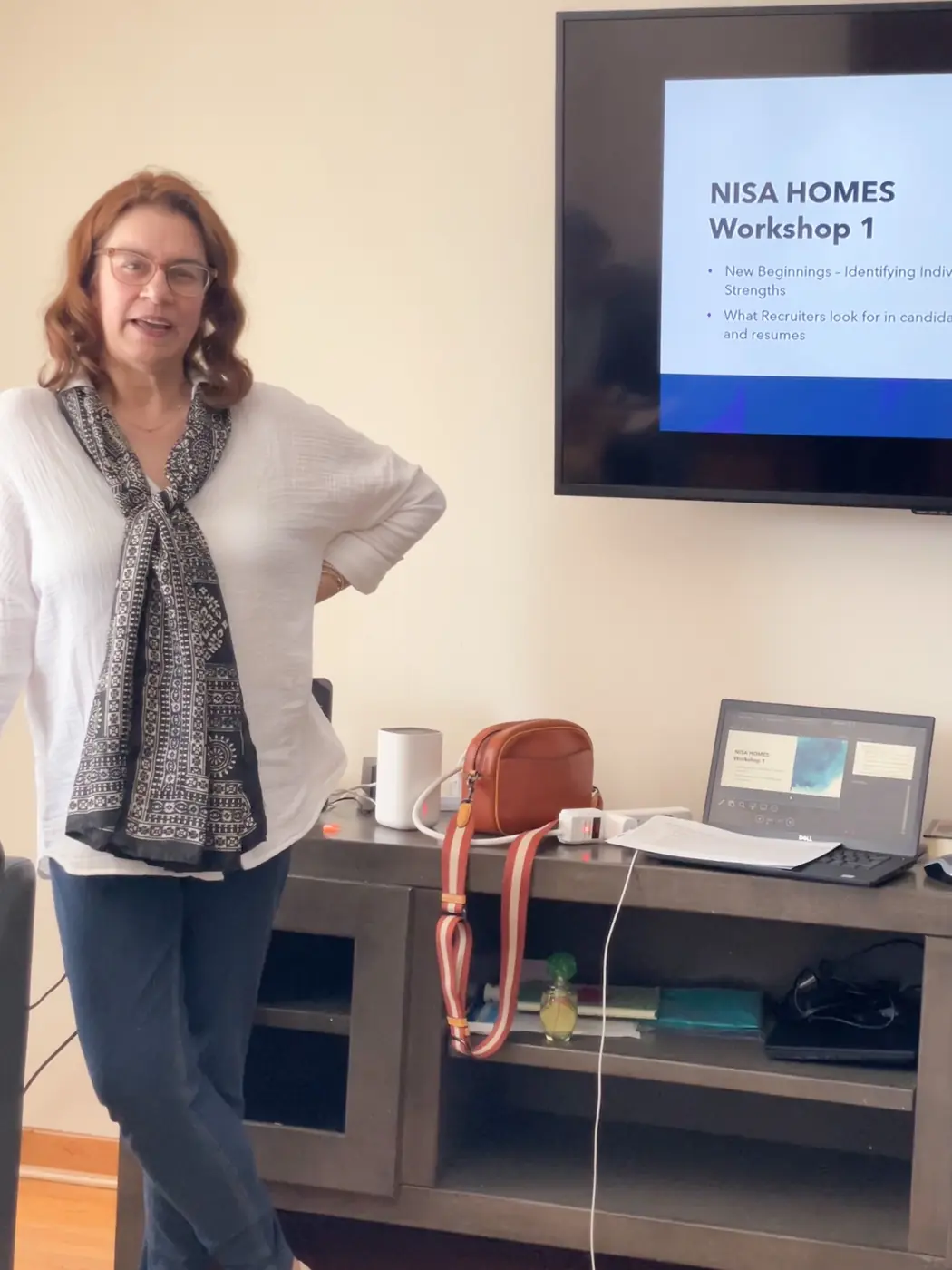 A facilitator leading a life skills workshop in front of a presentation screen