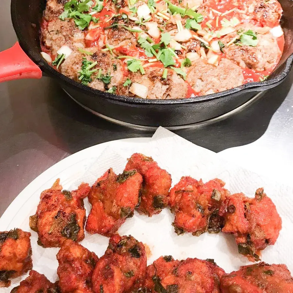 Home-cooked dishes on plates and in a skillet