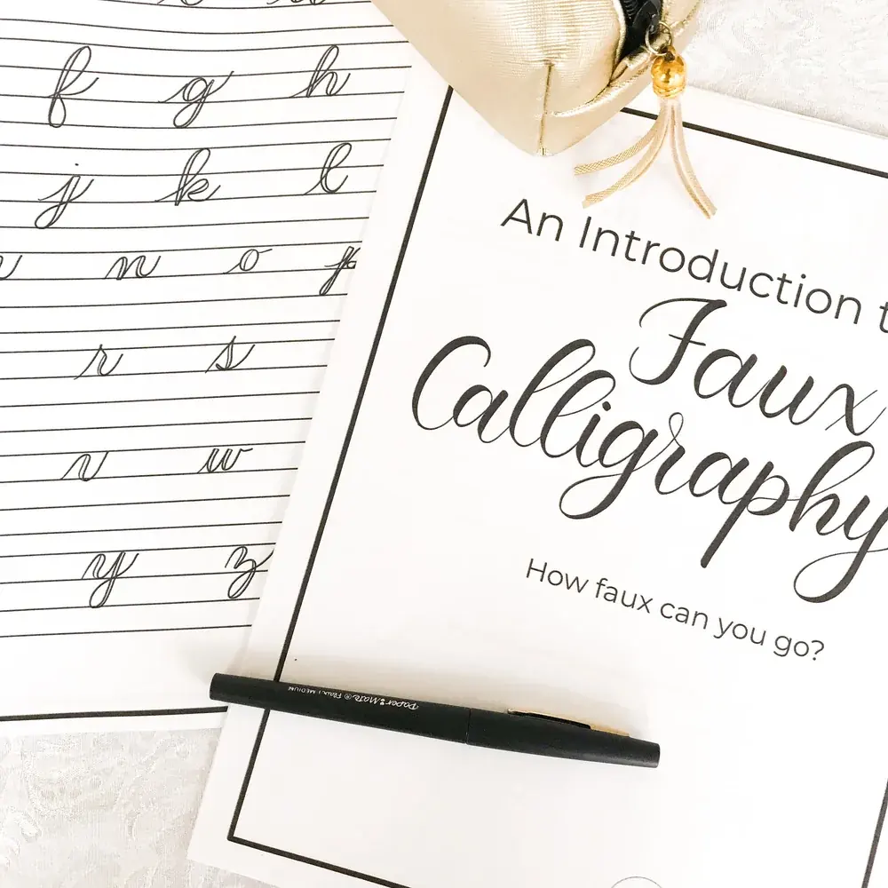 A faux calligraphy worksheet with a pen
