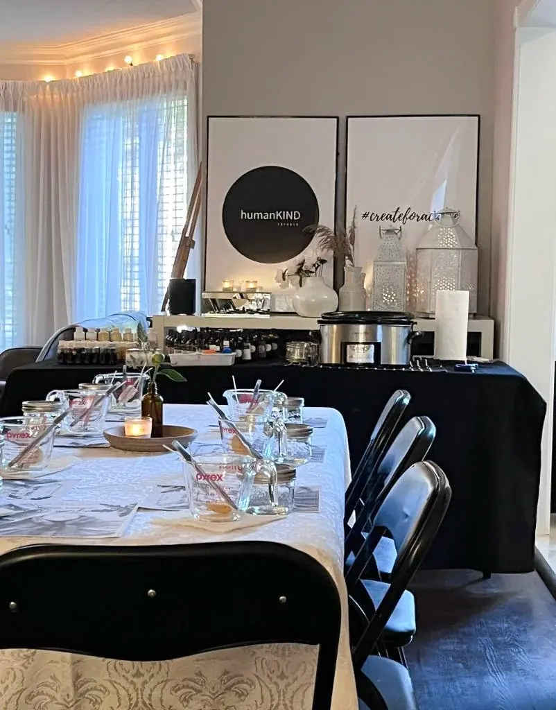A candle workshop room set with long tables and string lights