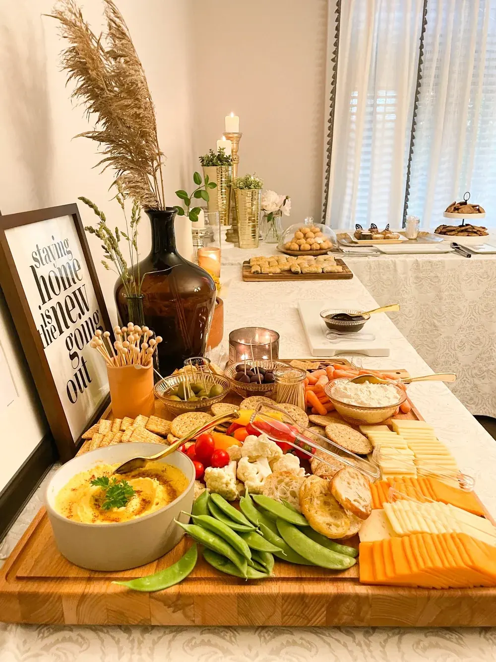 A grazing table with dips, vegetables and cheese