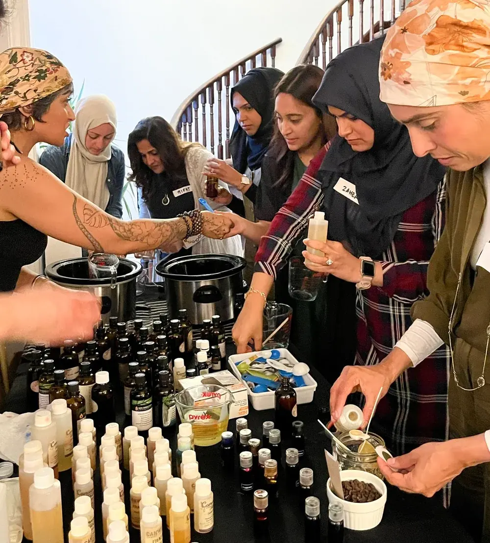 Guests gathered around a table of essential oils