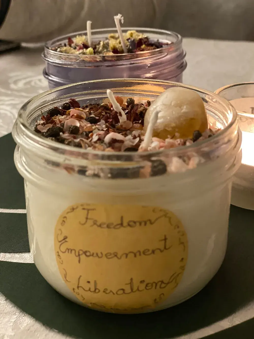 A finished hand-poured candle in a glass jar with a handwritten label