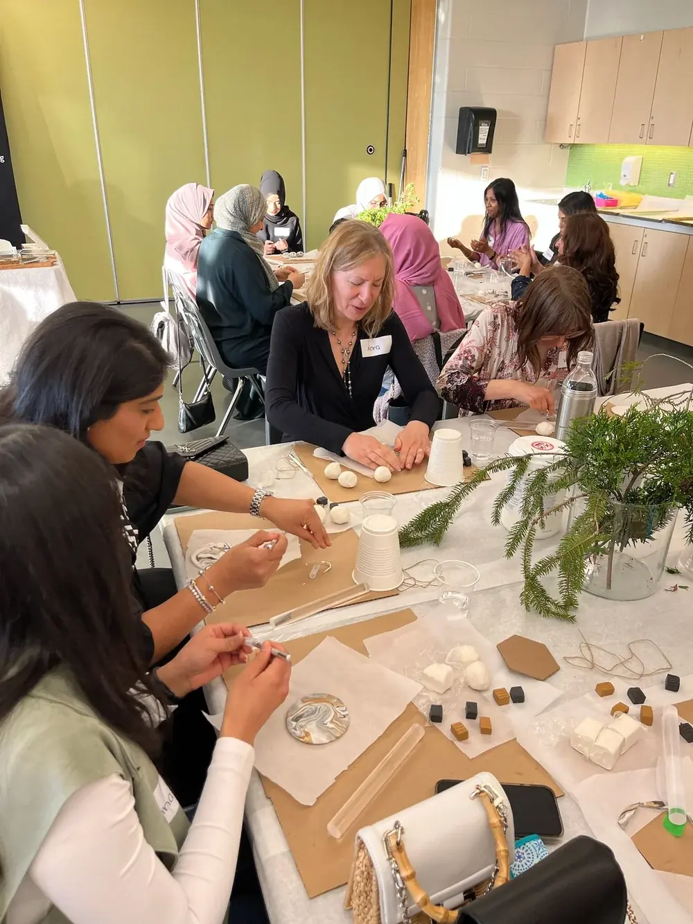 Women working on crafts around a decorated table