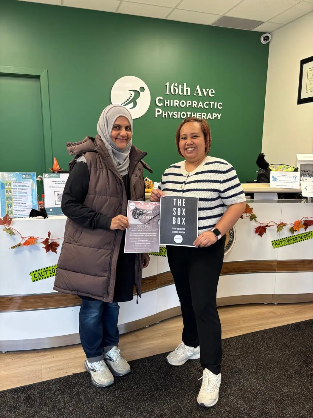 Partners at a local clinic hosting a sock collection box