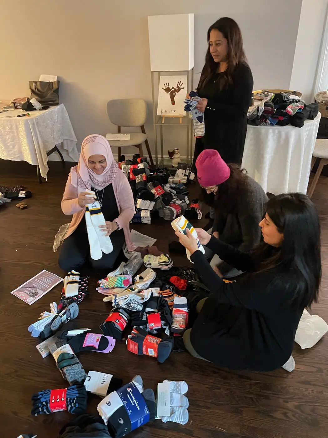 Volunteers sorting donated socks on the floor