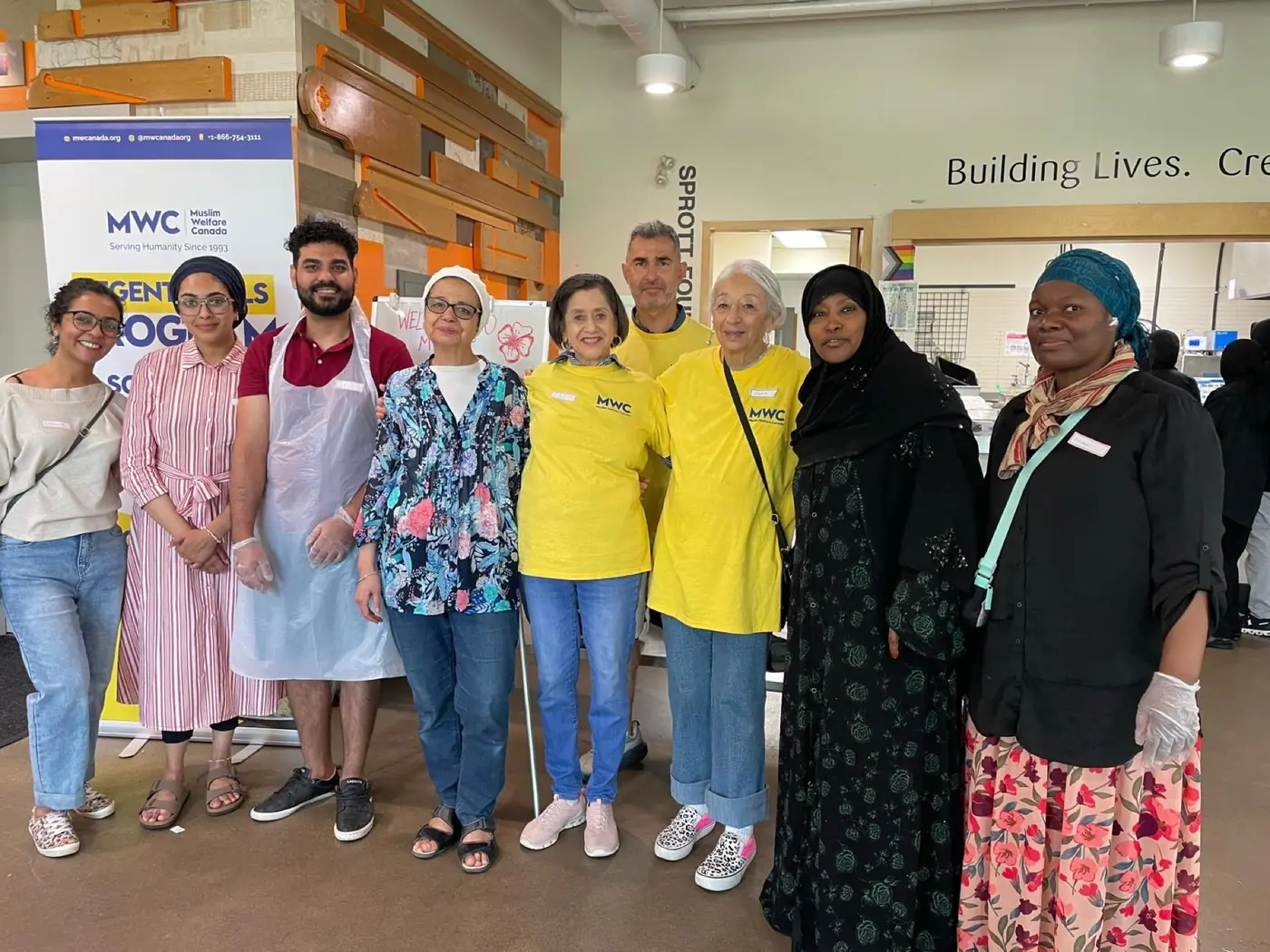 Volunteers in aprons and matching shirts at a community kitchen